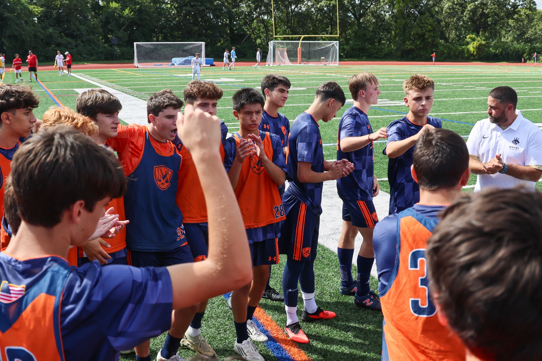 Gabe Ramos in a pre-match huddle with the Manhasset varsity team